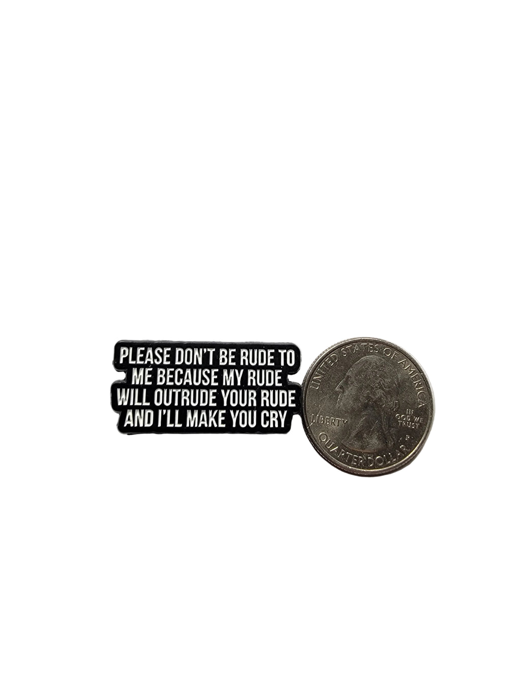 Black and white enamel pin with text next to a quarter on a white background
