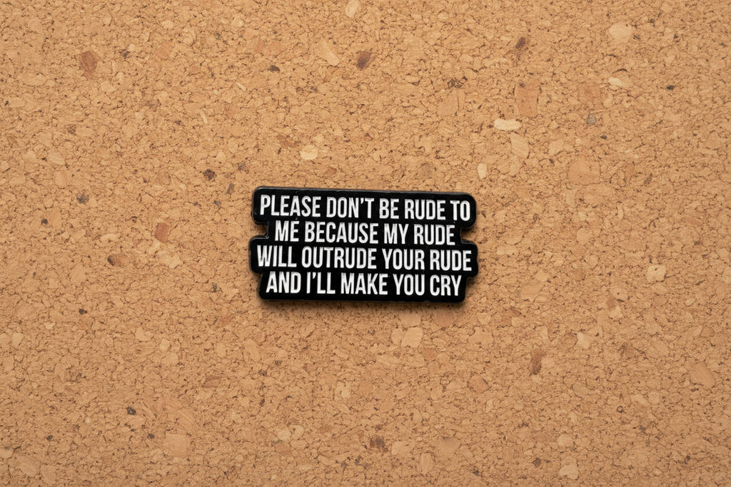 Black metal badge with white text on a cork background