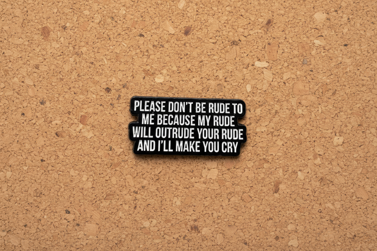 Black metal badge with white text on a cork background