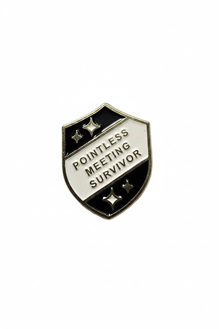 a black and silver pin with text
