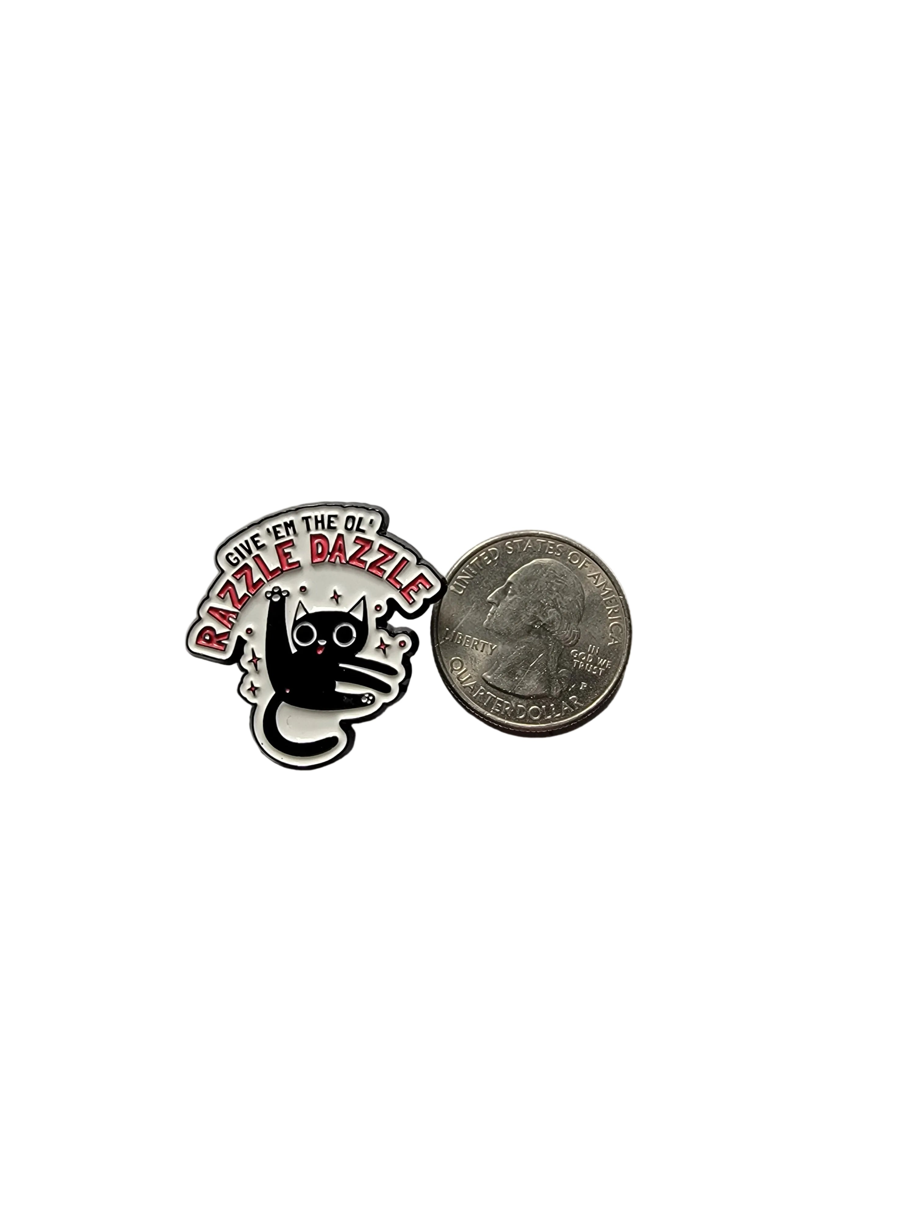 a funny cat pin with text next to a quarter on a white background