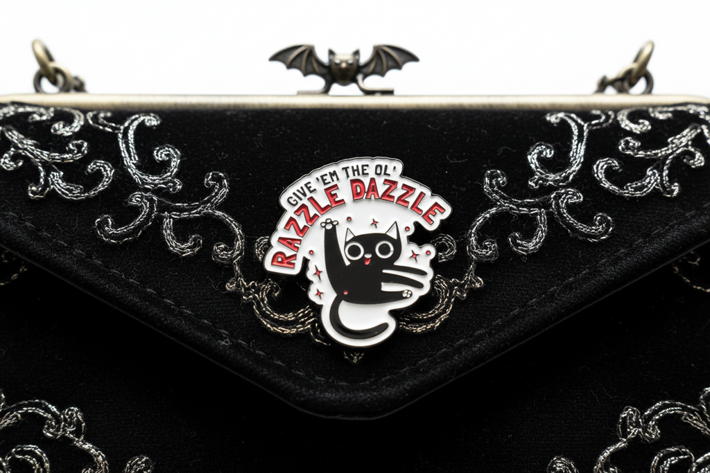 a white enamel pin with a cat and funny saying on a black purse background