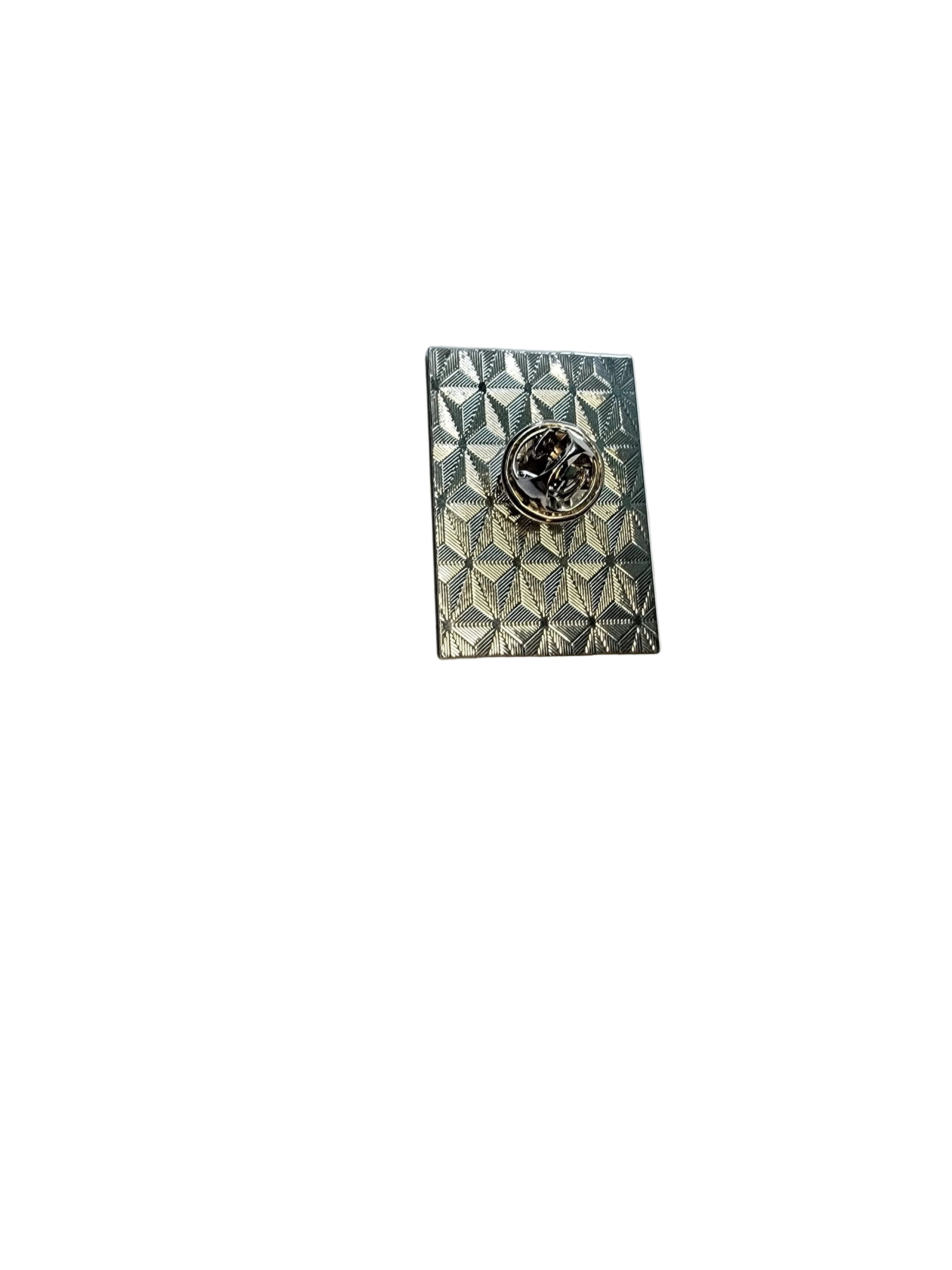 Decorative metal pin back on a plain white background