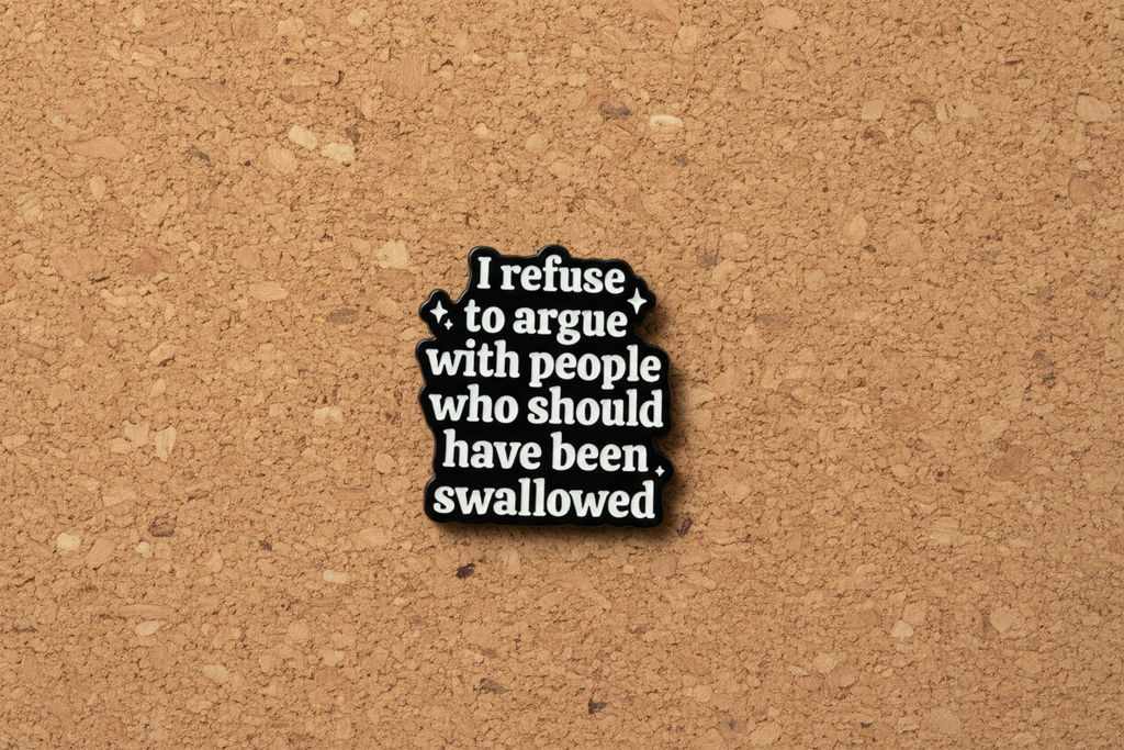 Black and white text pin on a cork background