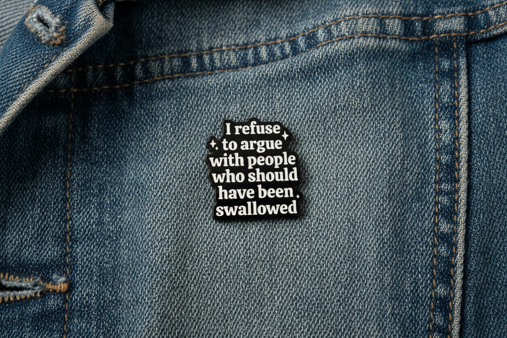 Black and white text pin on a denim background