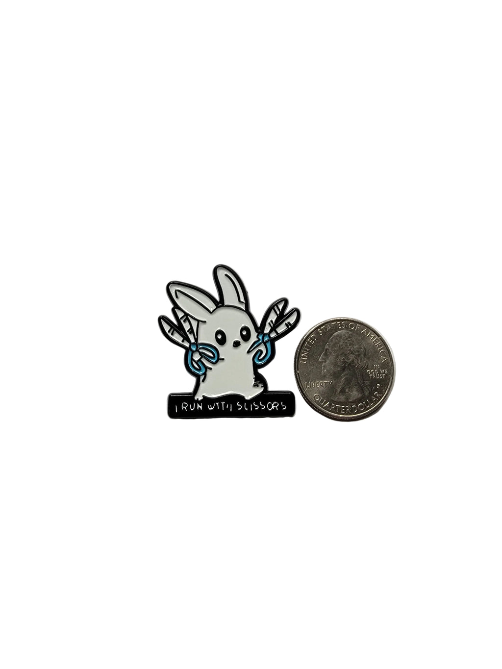 Small decorative item resembling a rabbit with a coin and cylindrical object on a gray background