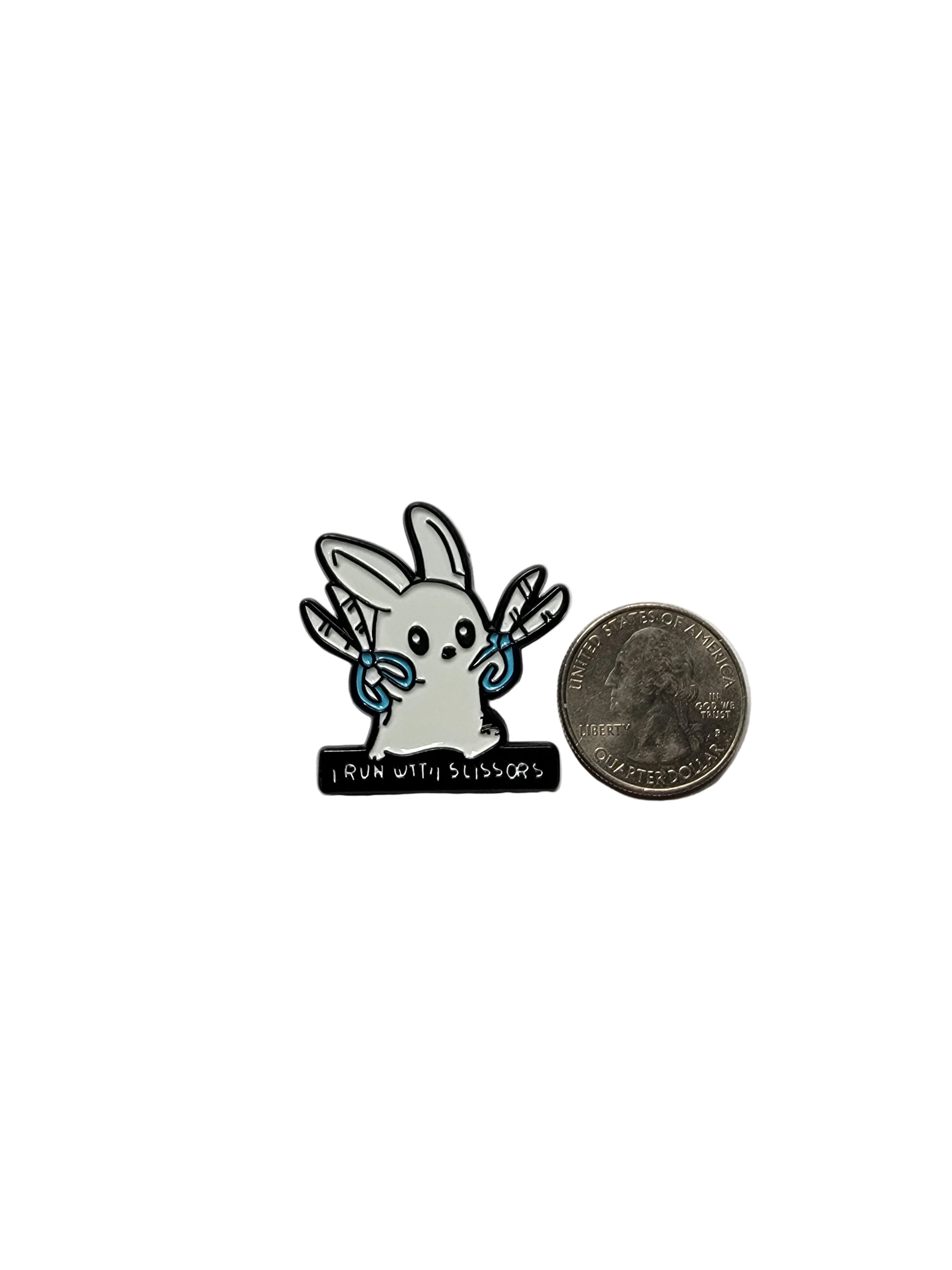 Small decorative item resembling a rabbit with a coin and cylindrical object on a gray background