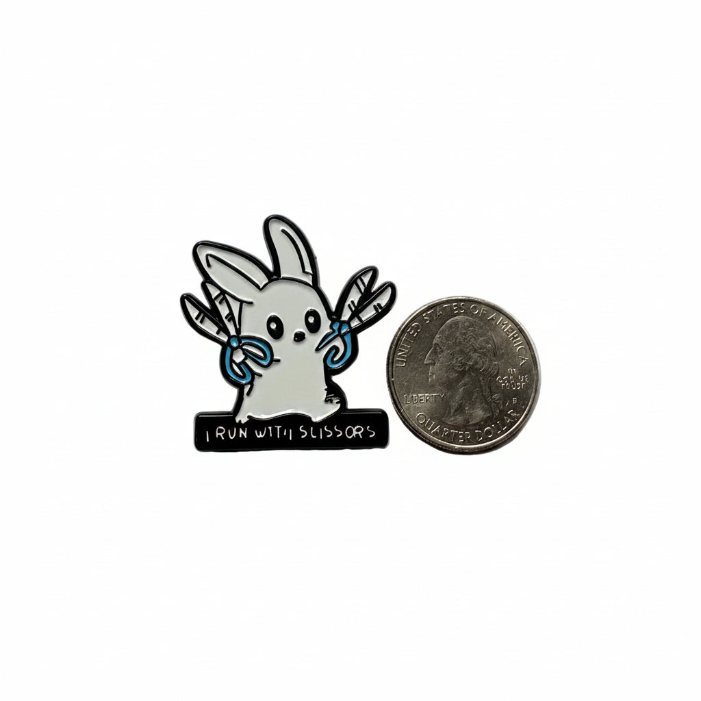 I run with scissors enamel pin shown next to quarter for size reference funny enamel pin dims 1 1/4 in W X 1 1/4 in H
