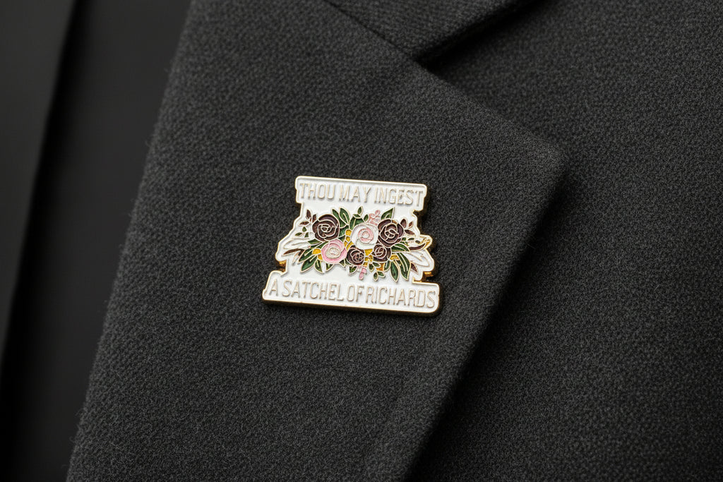 a floral enamel pin with text that says thou may ingest a satchel of richards on it on a gray lapel