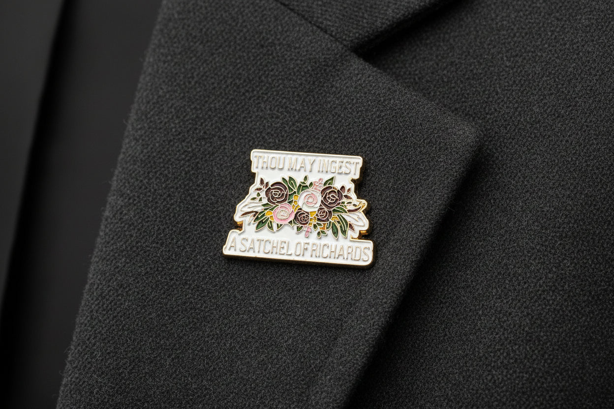 a floral enamel pin with text that says thou may ingest a satchel of richards on it on a gray lapel
