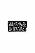 Black and white enamel pin with 'SHENANIGAN ENTHUSIAST' text on a gray background
