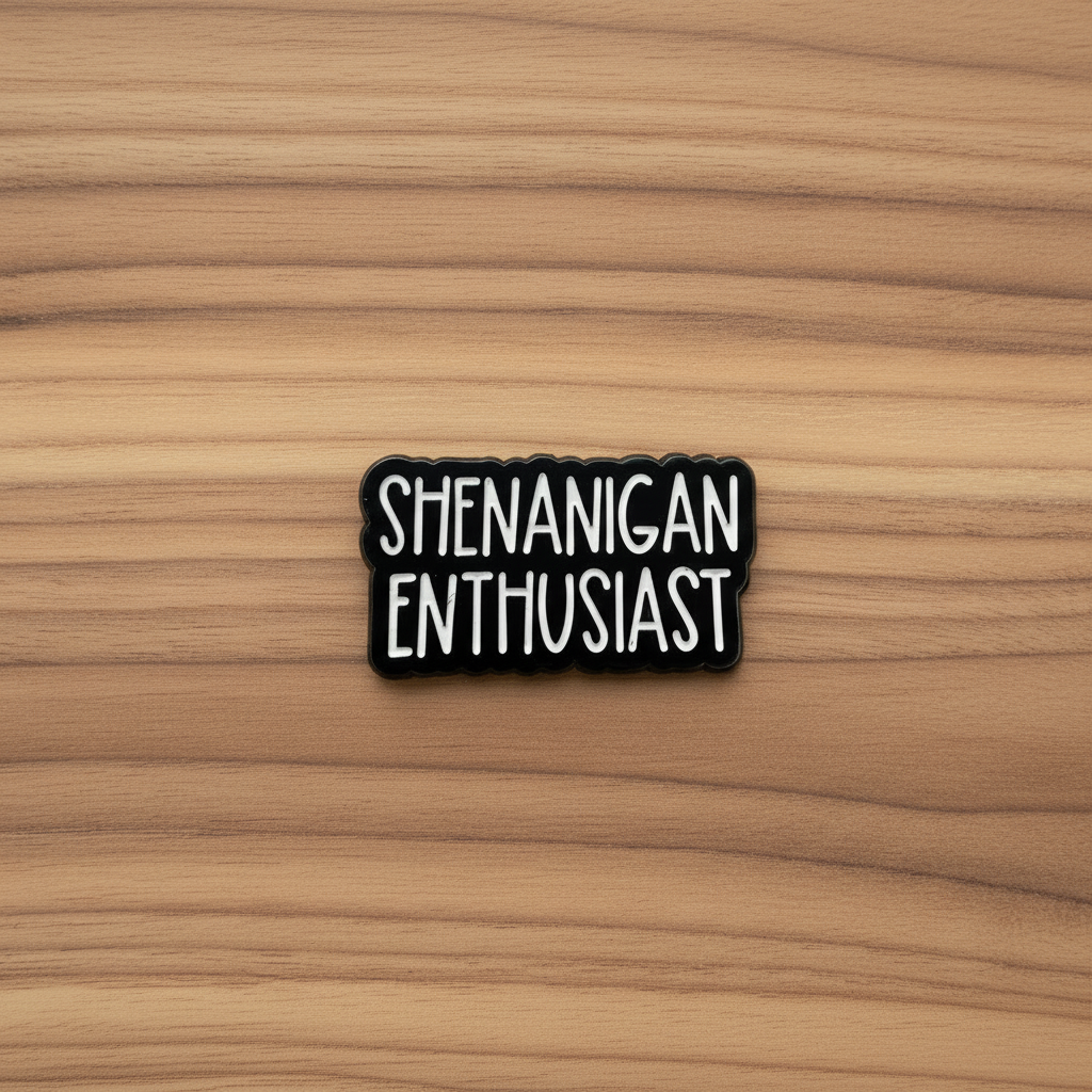 Shenanigan Enthusiast enamel pin on wood background funny enamel pin with text detail