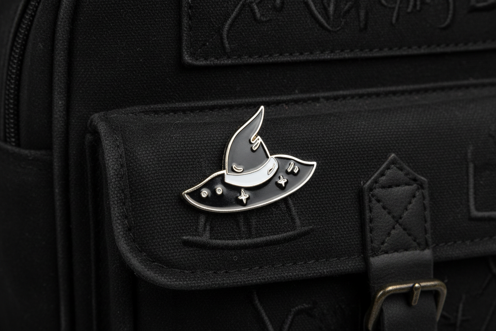 silver and black witch hat enamel pin on backpack Halloween accessory for customizing bags and school gear