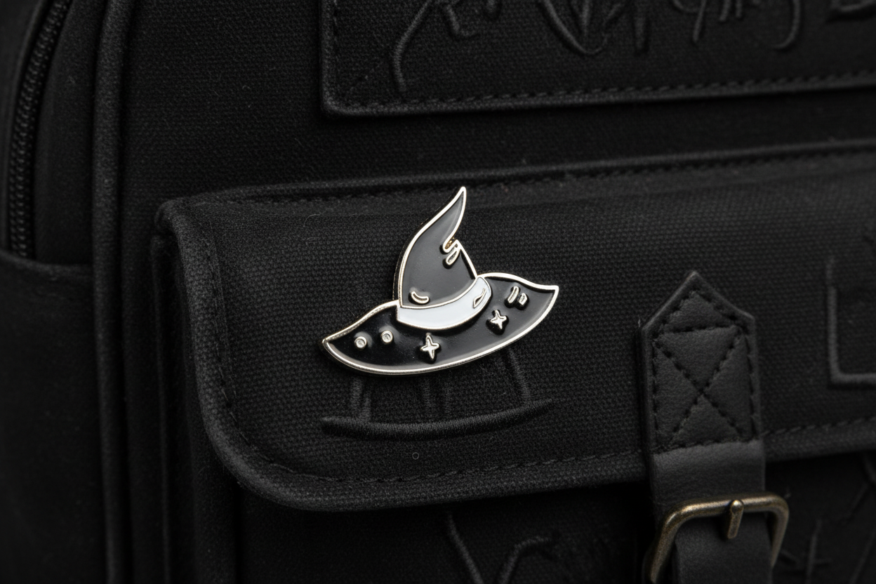 silver and black witch hat enamel pin on backpack Halloween accessory for customizing bags and school gear