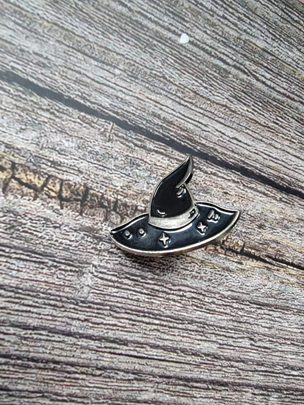 silver witch hat enamel pin on wood background goth enamel pin with black witch hat sparkle detail