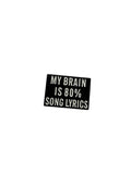 Small black rectangular pin with white text on a light gray background