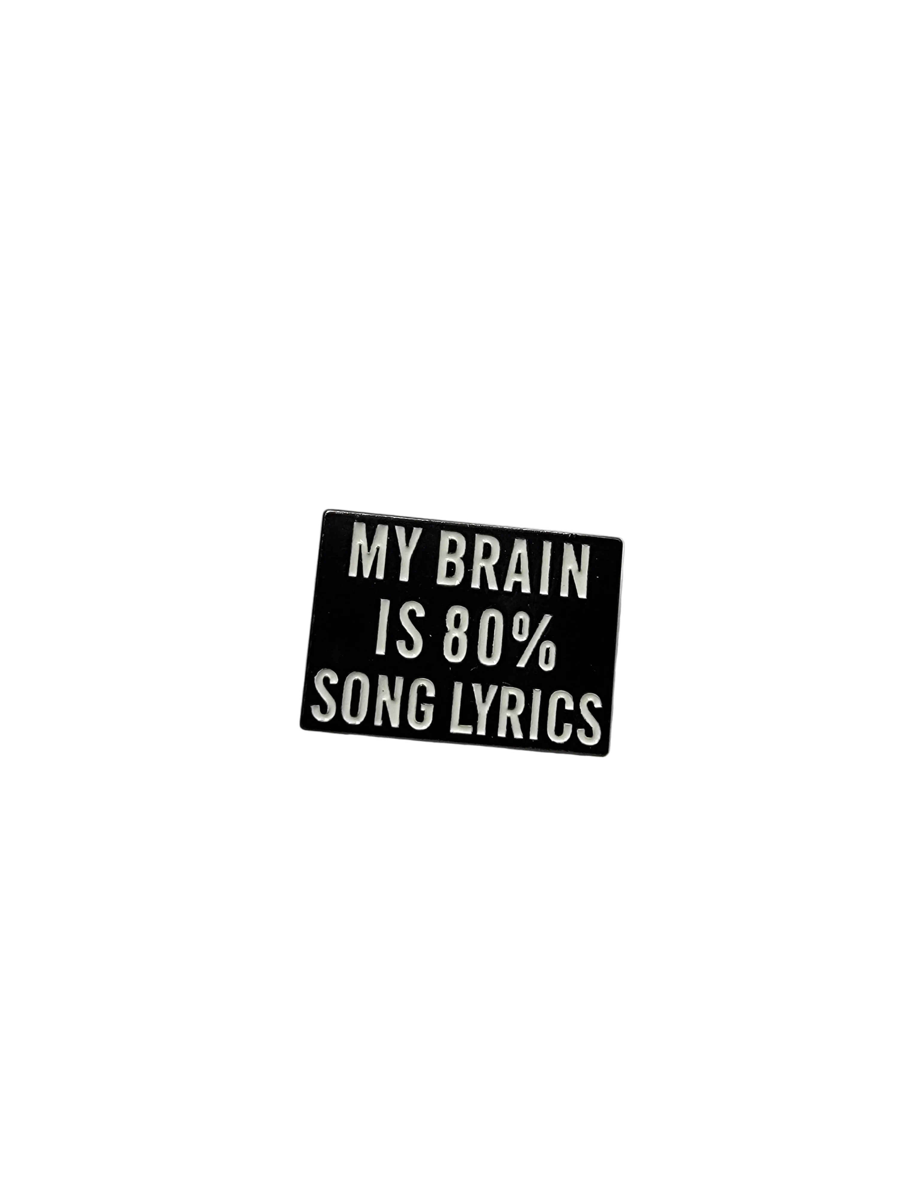 Small black rectangular pin with white text on a light gray background
