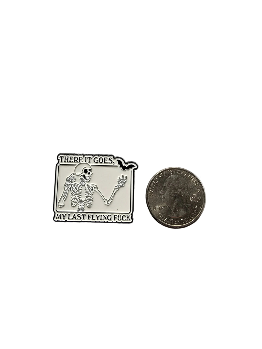Small rectangular metal badge with skeleton design and text on a gray background