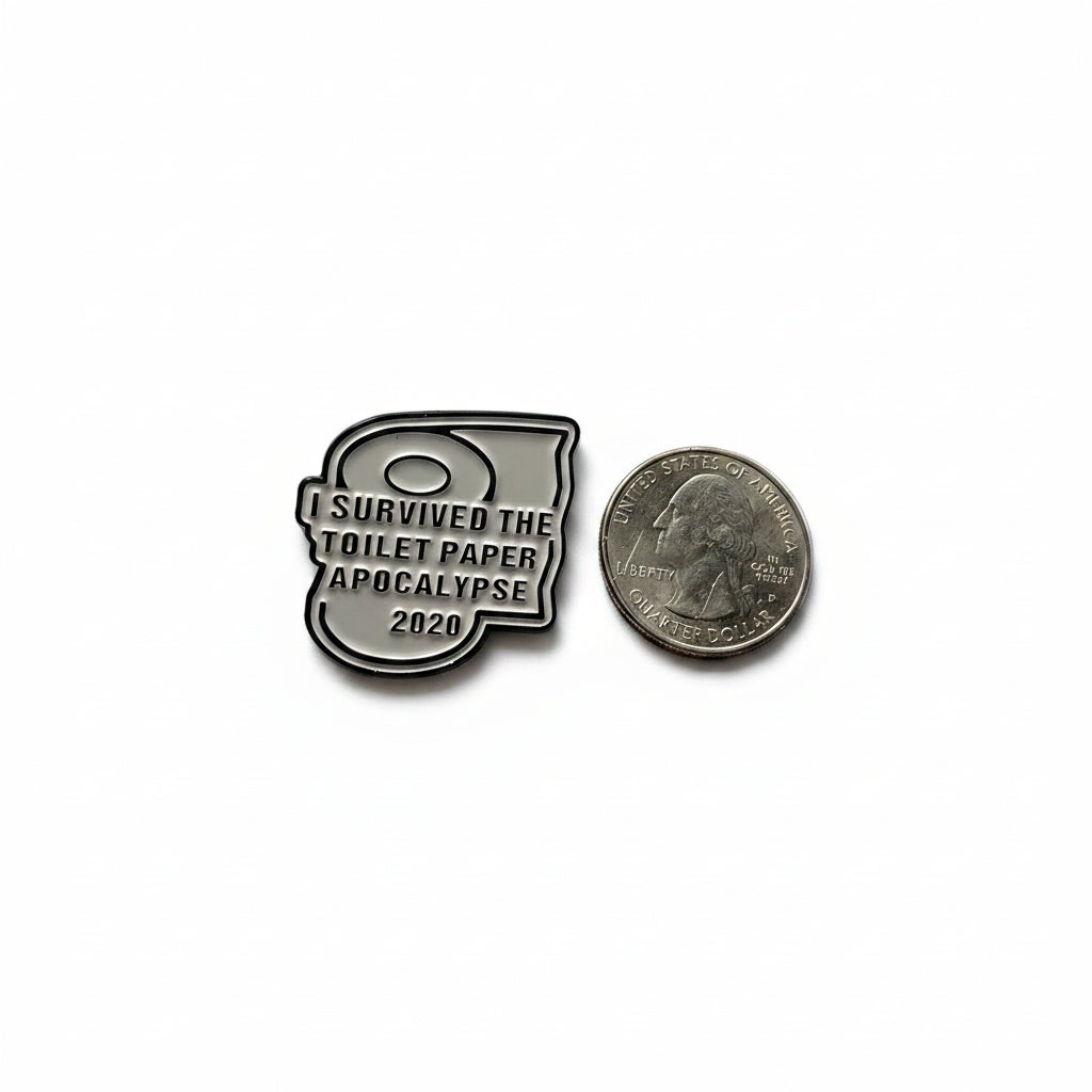 I survived the toilet paper apocalypse of 2020 enamel badge shown next to quarter for size reference silly enamel pin dims 1 1/4 in W x 1 in