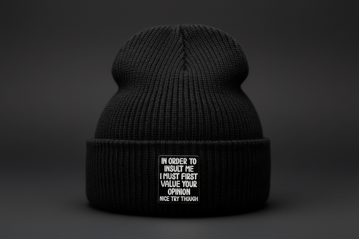 Black square with white text on a black beanie background