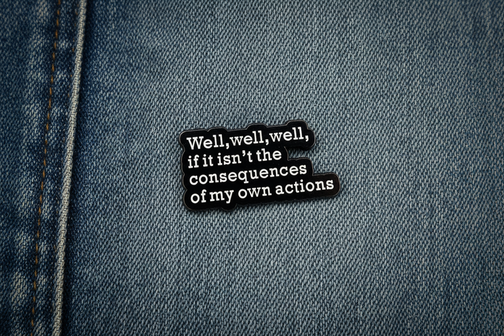 Black and white text pin on a denim background