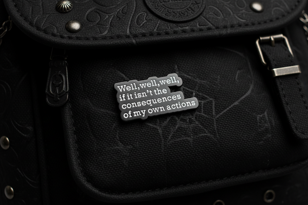 Black and white text pin on a black bookbag background