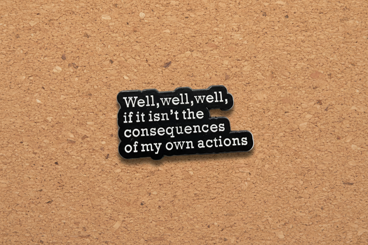 Black and white text pin on a cork background