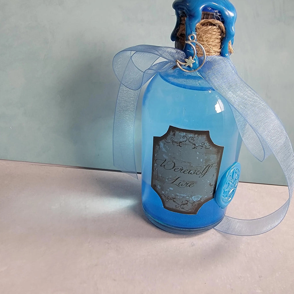 Blue bottle with decorative label and ribbon on a neutral background