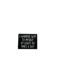 Small black pin with white text on a gray background