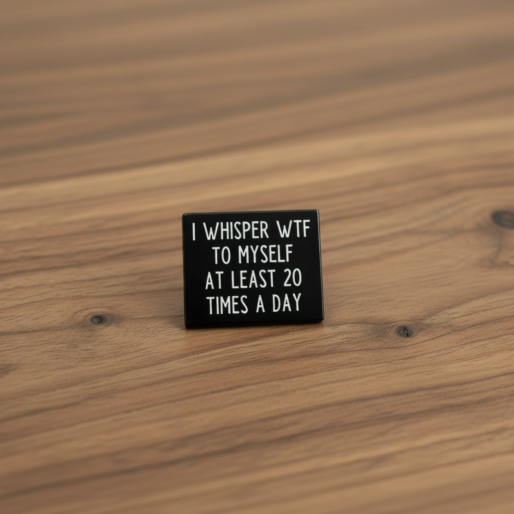 I whisper wtf to myelf at least 20 times a day enamel pin on wood background sassy enamel pin with black and white text detail