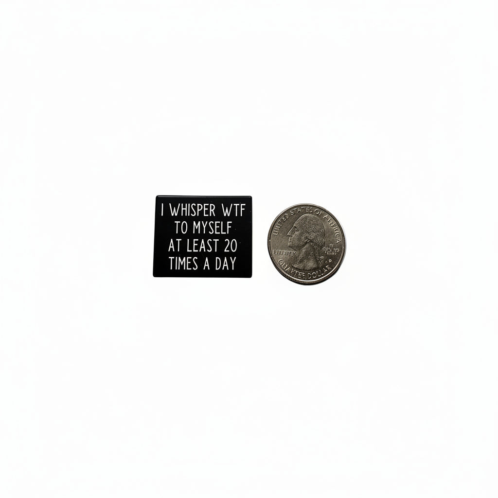 I whisper wtf to myself at least 20 times a day enamel pin shown next to quarter for size reference sarcastic enamel pin dims 1 1 /8 in W X 7/8 in H