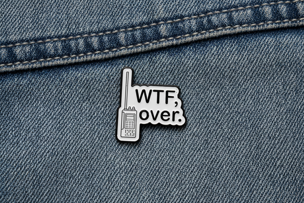 Pin with 'WTF over.' text on a denim background